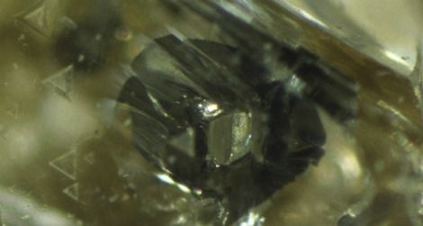 A hexagonal grain of iron sulfide in a diamond may be a flaw for jewelers, but it's useful data for scientists