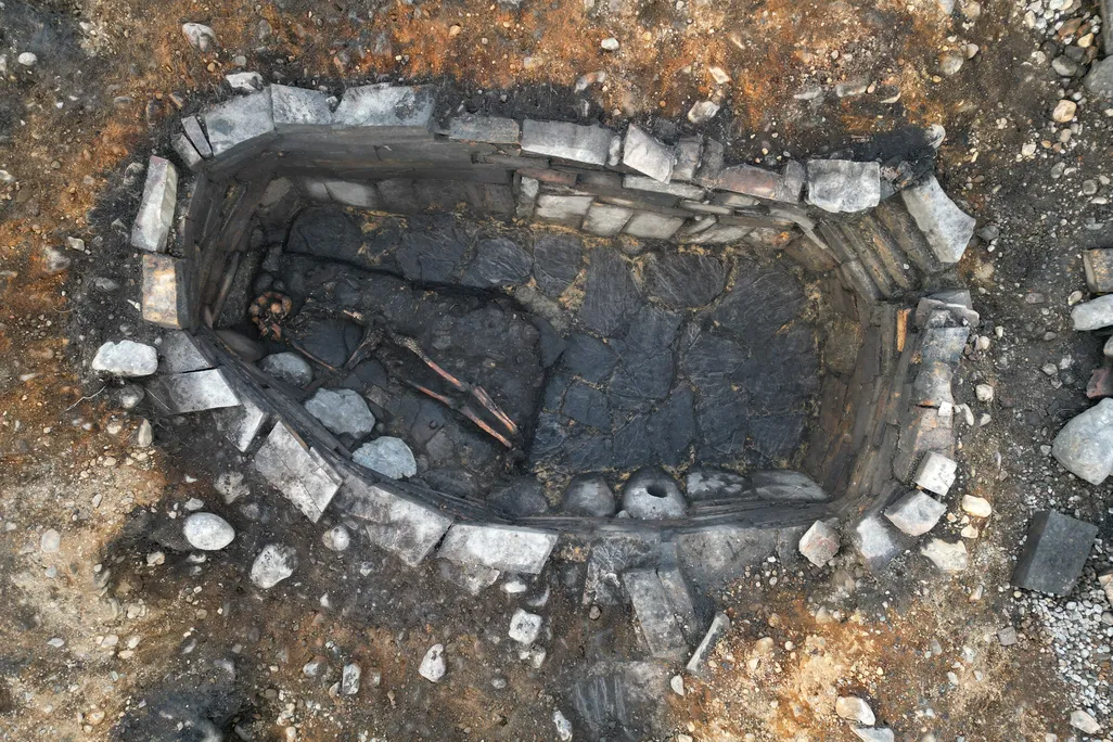 Looking down into a pit lined with stones