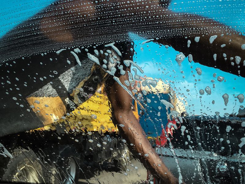 A squeegee guys wipes the windscreen clean Smithsonian Photo Contest