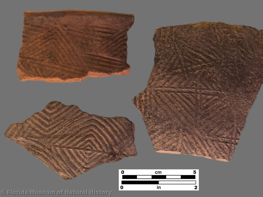 three pieces of pottery with patterns of squares and triangles pressed into them