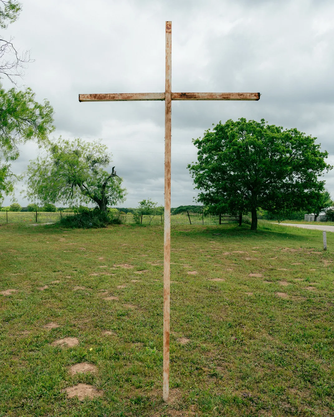 a cross stands in a field