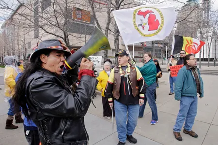 Philip Yenyo, executive director of the American Indian Movement for Ohio, leads a protest of the Cleveland Indians Chief Wahoo mascot before a baseball game against the Detroit Tigers Friday, April 10, 2015, in Cleveland.