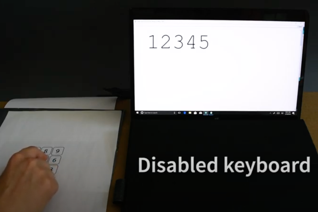 Paper keypad next to laptop