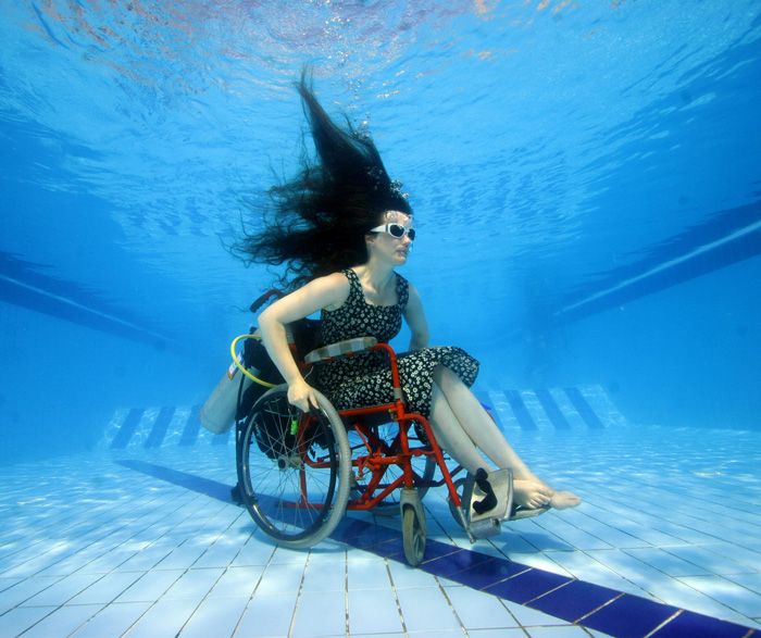 Artist Sue Austin scopes out a pool in her underwater wheel chair.