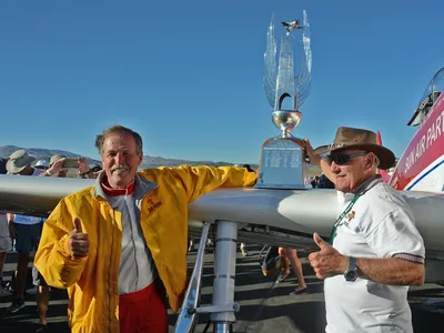 We are the champions: Pilot Hoot Gibson (left) and owner Tiger Destefani celebrate Strega’s 12th win at the National Championship Air Races.
