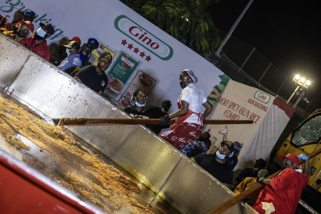 Nigerian chef Hilda Baci stirs rice in a giant pot during an attempt to set the world record for the largest pot of jollof rice.