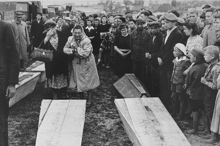 Women grieving over the coffins of those killed in the Kielce pogrom as they are transported to the burial site in the Jewish cemetery.