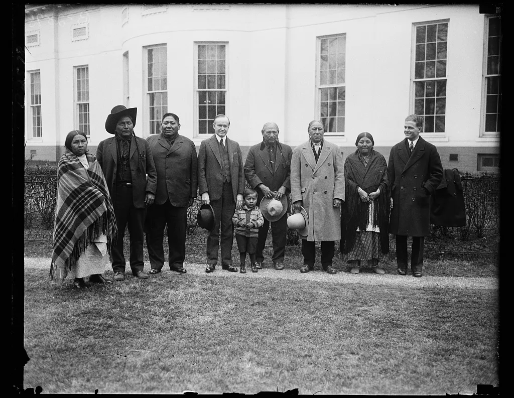 Coolidge poses with members of a Comanche delegation in 1928.