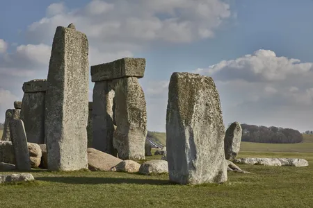 Behind Stonehenge's iconic stone structures, a busy road creates constant noise and is prone to traffic jams.