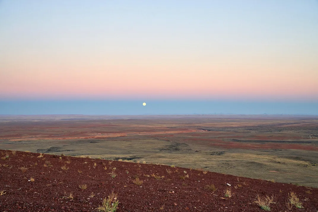 Moonrise and Earth’s shadow looking east in Arizona desert 
