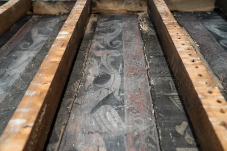 Birds with teeth, little men in triangular hats and other fanciful figures appear in the Tudor wall paintings.
