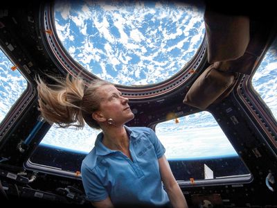 Astronaut Karen Nyberg enjoys the magnificent view from the ISS Cupola in 2013.
