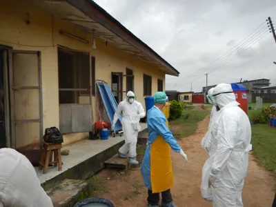 World Health Organization workers gear up to go into an old Ebola isolation ward in Lagos, Nigeria. 