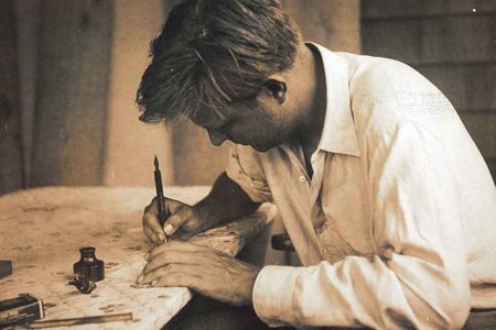 Robert Motherwell writing at his desk in Amagansett, New York, June 1944