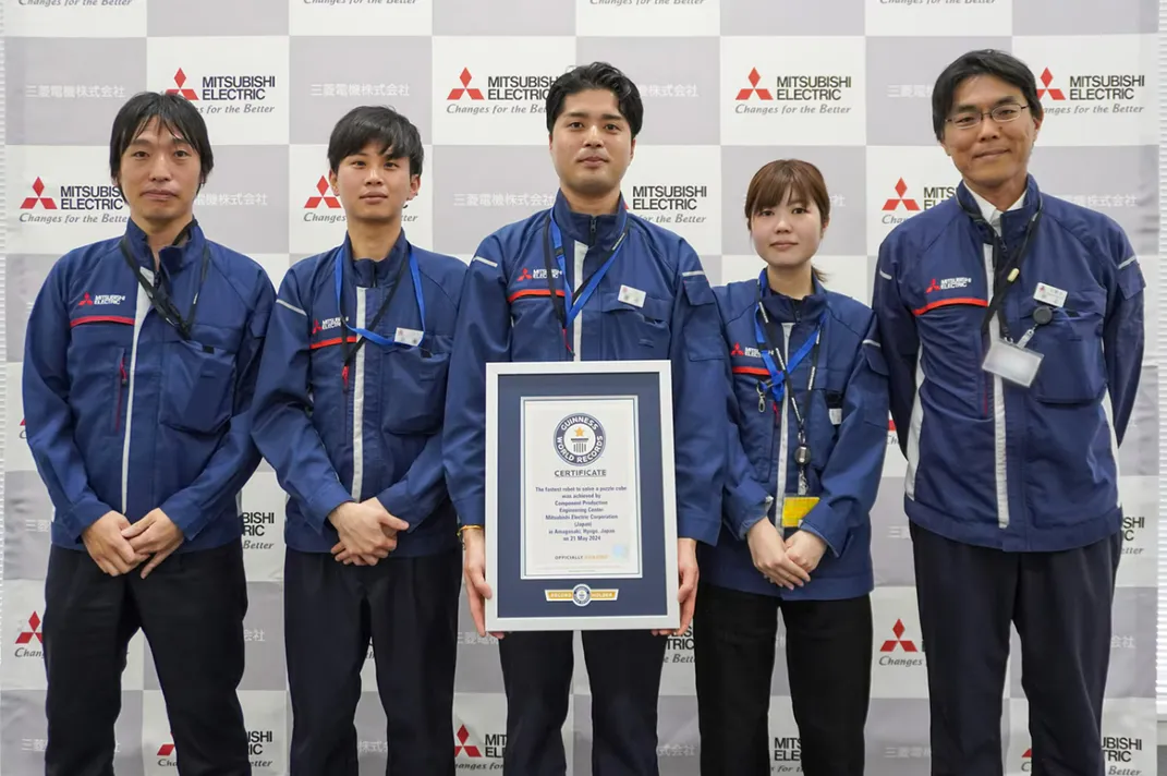 The engineers who helped develop TOKUFASTbot pose with their Guinness World Records award