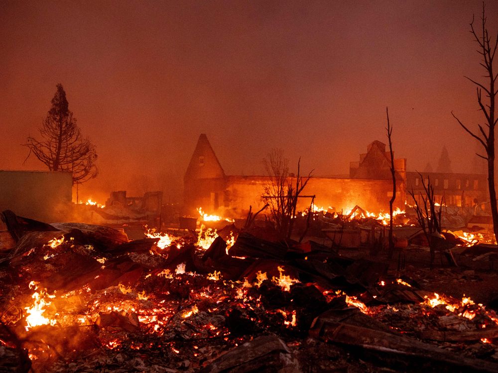 Buildings burn as the Dixie fire tears through downtown Greenville, California on August 4, 2021.