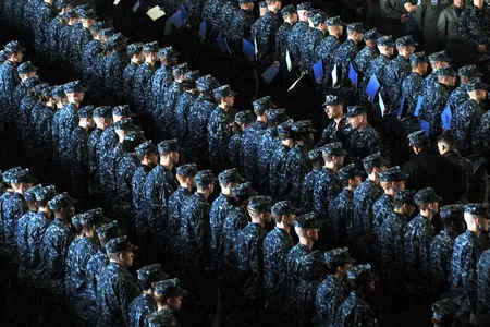 A newly promoted group of petty officers stand in formation in Yokosuka, Japan. The blue working uniforms they are wearing will start to be phased out this October.
