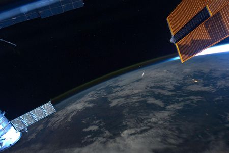 Astronaut Ron Garan photographed a streaking meteor (center) from on board the space station during the 2011 Perseid shower.