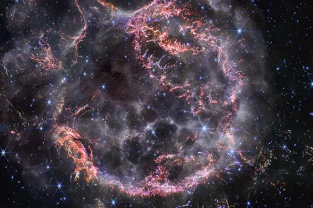 The supernova remnant Cassiopeia A, captured by NASA&#39;s James Webb Space Telescope in near-infrared light. The image shows the expanding material from the blast colliding with gas released by the star before the explosion.