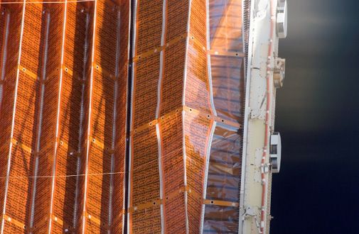 A balky solar array forces an extra spacewalk.