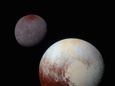 A composite of enhanced color images of Pluto (lower right) and Charon (upper left), taken by NASA&rsquo;s New Horizons spacecraft on July 14, 2015.