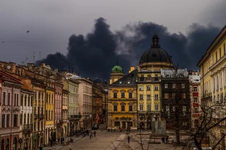 After an attack by Russian forces in late March, smoke rises from an oil depot not far from Rynok Square in Lviv in western Ukraine