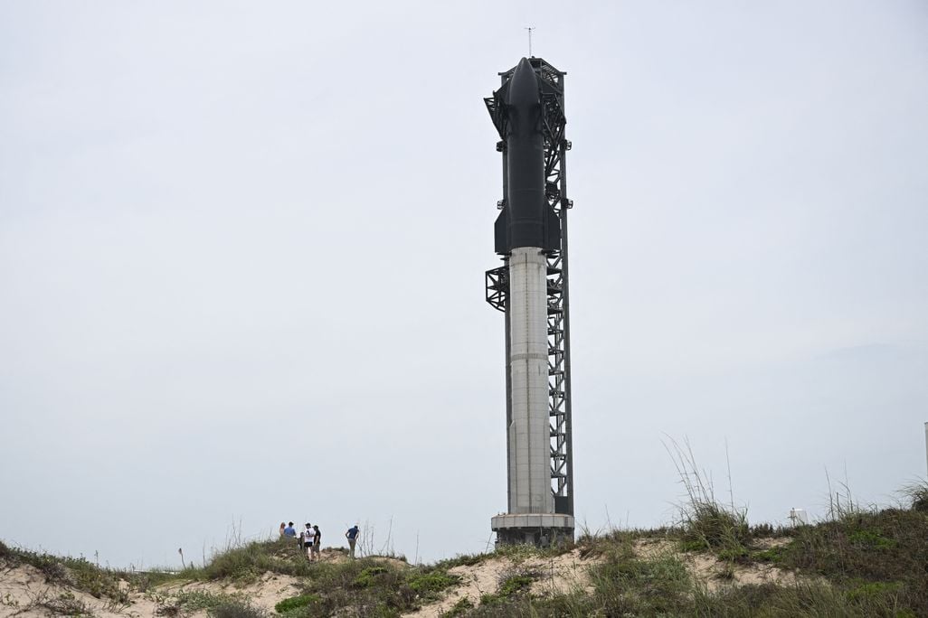 The Starship rocket stands on its launch pad