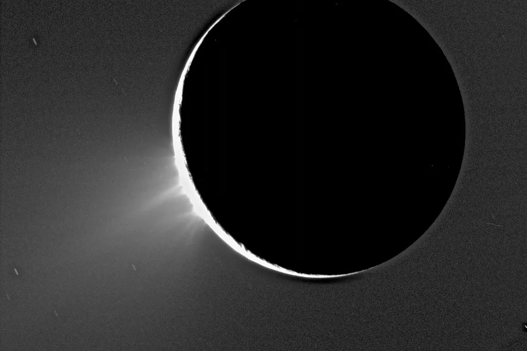 A photo of water ice plumes spewing from Saturn's moon Enceladus taken by NASA's Cassini spacecraft 