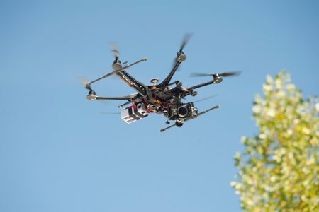An unmanned Aerial Vehicle (UAV) / drone used for aerial surveillance is flying in the air.