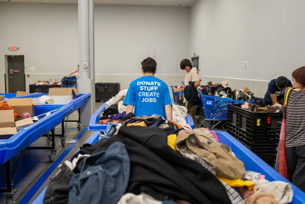 An employee moves bales of clothing at a Goodwill Outlet Center on July 27, 2022, in Hackensack, New Jersey.