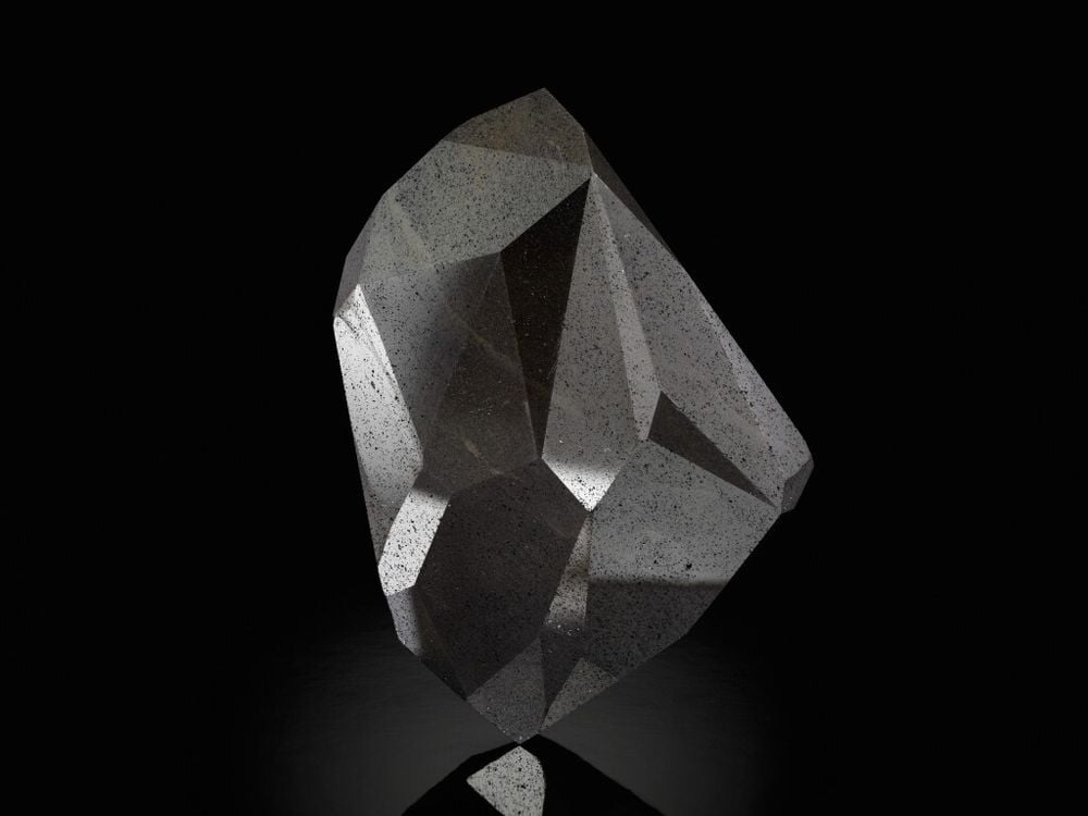 A large black gemstone with 55-facets