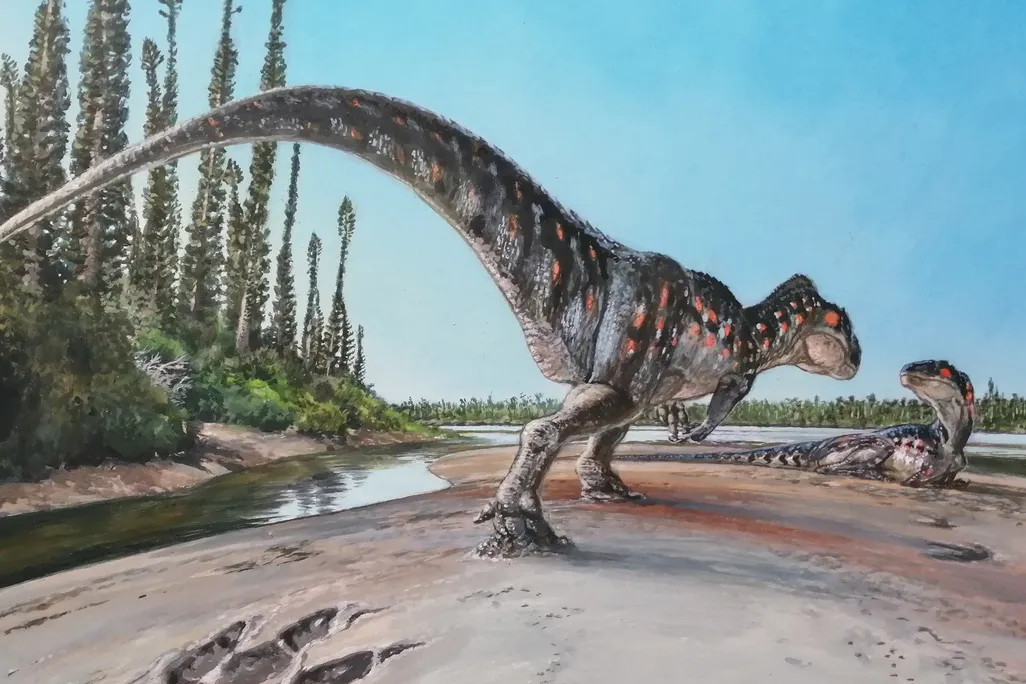 Illustration of one dinosaur standing and another laying down on a coastline