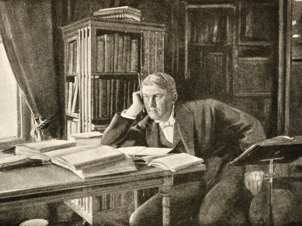 Thomas Alva Edison thinking at his desk