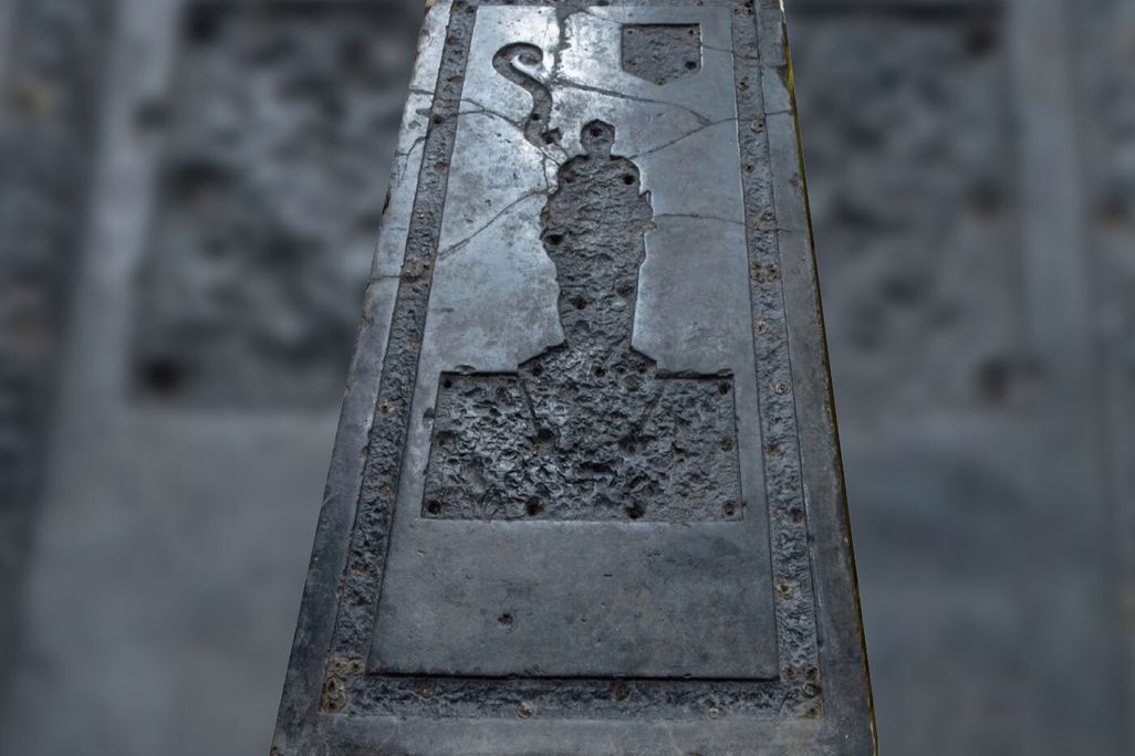 Black slab of stone with indentation