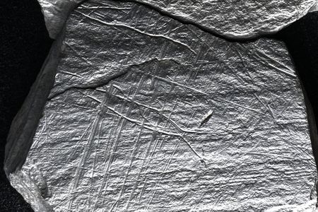 The engraved plaquettes sport grid-like patterns that researchers think represent fishing nets.