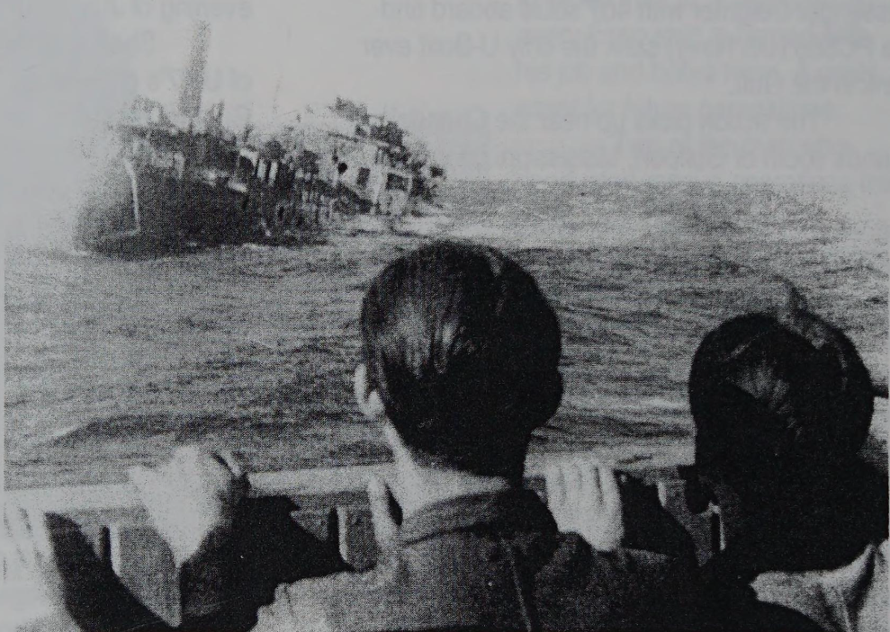 German soldiers watch the sinking of the HMS Empire Mica from the bridge of their U-boat, U-67, on June 29, 1942.