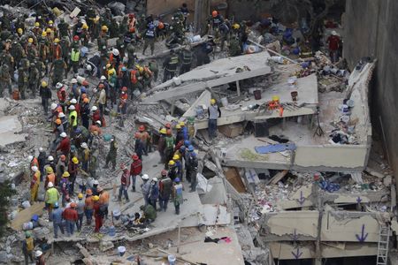 Rescue workers search for survivors among the rubble of a collapsed building in Mexico City. Structures throughout the capital were devastated during yesterday's earthquake.