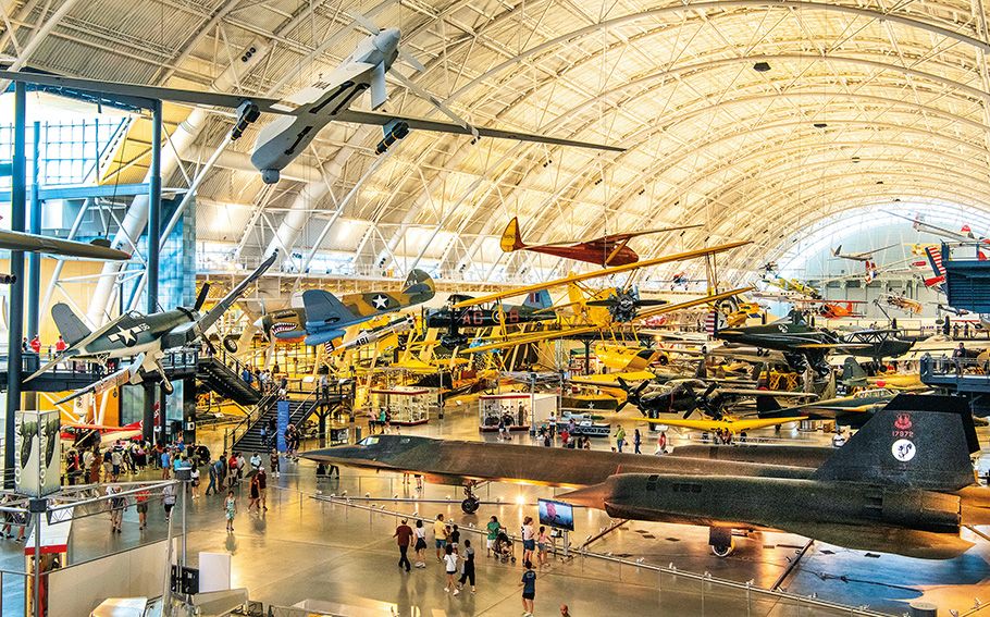 The Boeing Aviation Hangar at the Steven F. Udvar-Hazy Center is a vast open space filled with airplanes on both the floor and hanging from the ceiling, tilted at angles that convey the impression of flight.