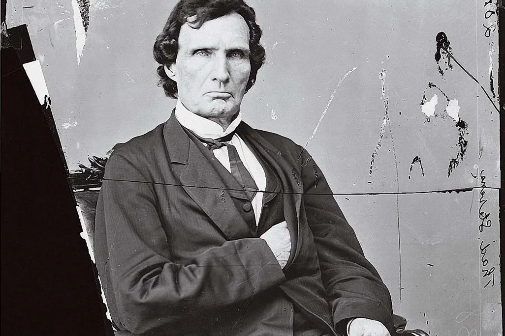 a formal portrait of a man sitting