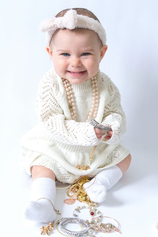 The happiness of an infant while playing with mommy's jewelry thumbnail