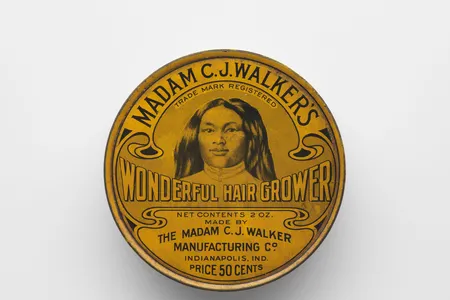 On the lid of the two-ounce can of Madam C. J. Walker’s Wonderful Hair Grower, her top-selling product, appears an African-American woman with thick, flowing hair. That woman was Walker herself.