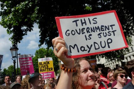 Protestors in London attack the coalition between the Conservative Party and the Democratic Unionist Party from Northern Ireland on June 17, 2017. 