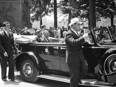 King George and Canadian Prime Minister William Lyon MacKenzie King ride in President Franklin Delano Roosevelt's car as the president drives them away from church on June 11, 1939.