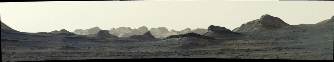 a long desert-like landscape beneath a pale sky