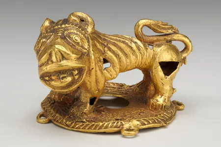 A gold lion ornament created by an Akan artist