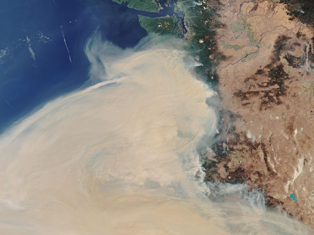 A satellite image shows wildfire smoke over the west coast of the United States