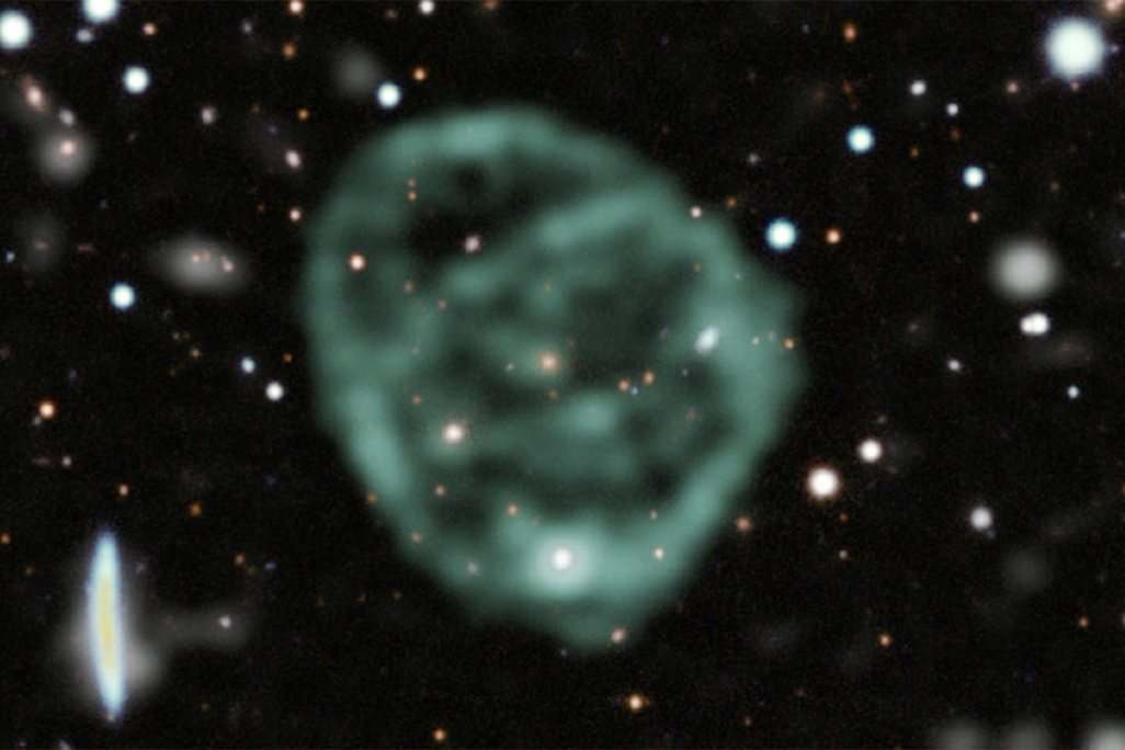 A blurry light-green circle surrounded by stars in space
