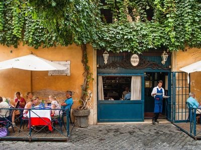 Diners eat lunch outdoors at the Osteria Margutta. 