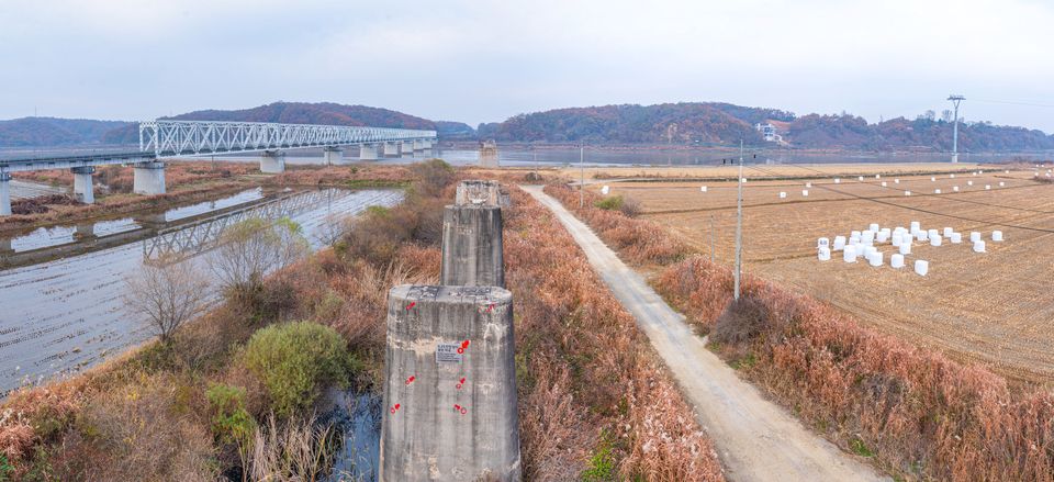  The pilings of a destroyed bridge bear marks of past conflict in the DMZ. 