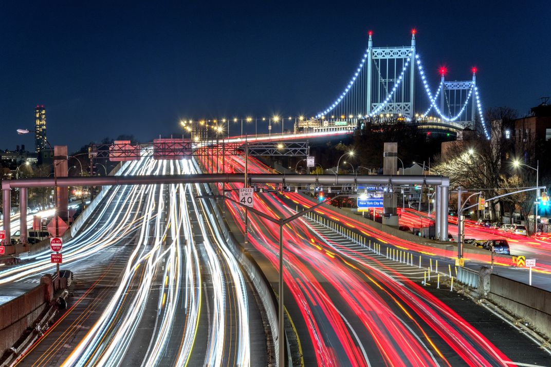 Vehicle headlights and brake lights streak in this photo